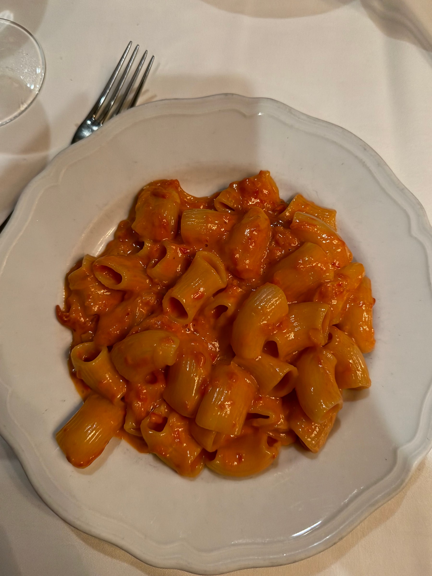 Spicy rigatoni in glossy vodka sauce on a patterned Italian platter at Carbone in New York