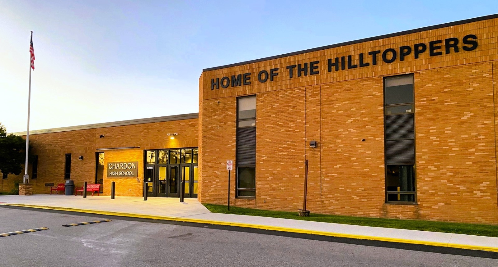 The brick entrance of Chardon High School beneath the words Home of the Hilltoppers